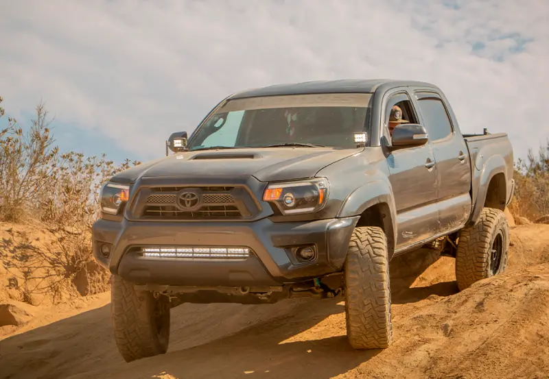 Cali Raised 05-15 Toyota Tacoma Low Prof Ditch Light Brackets Kit W/ Blue Backlight - Small 1